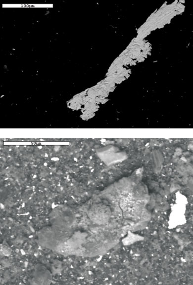 An iron shaving with scratch marks (top) and soil (above) were found in the oil sample. An iron shaving with scratch marks (top) and soil (above) were found in the oil sample.